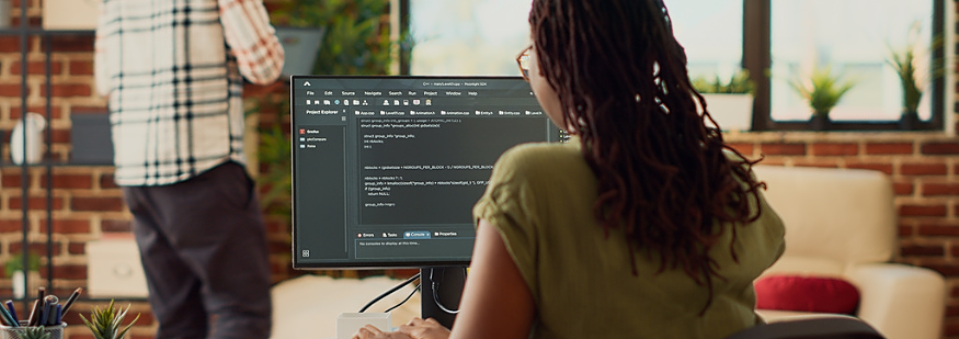 Young woman using source code to develop new online app, working with html script on terminal window to program database software. IT manager planning artificial intelligence network.