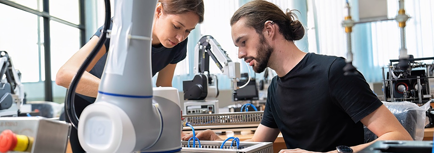 An engineer in research development robotic factory checking prototype of automation robot arm
