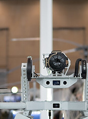 A drone featuring advanced surveillance equipment is showcased at a military expo, highlighting innovations in modern warfare and defense strategies.